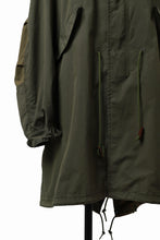 Load image into Gallery viewer, mastermind WORLD x ALPHA INDUSTRIES M-65 MODS COAT - CRAZY PANELED (OLIVE)
