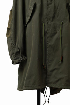Load image into Gallery viewer, mastermind WORLD x ALPHA INDUSTRIES M-65 MODS COAT - CRAZY PANELED (OLIVE)