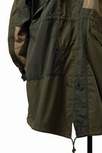 Load image into Gallery viewer, mastermind WORLD x ALPHA INDUSTRIES M-65 MODS COAT - CRAZY PANELED (OLIVE)