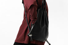 Load image into Gallery viewer, ISAMU KATAYAMA BACKLASH DRAWSTRING BACKPACK / MONOCHROME LUXURY STEER (BLACK)
