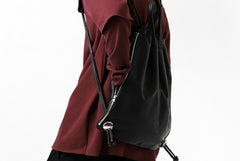 Load image into Gallery viewer, ISAMU KATAYAMA BACKLASH DRAWSTRING BACKPACK / MONOCHROME LUXURY STEER (BLACK)