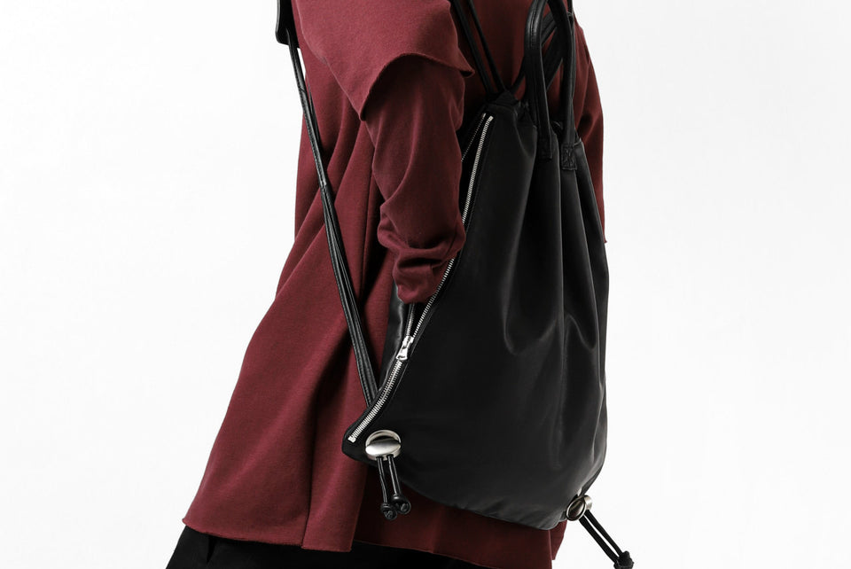 Load image into Gallery viewer, ISAMU KATAYAMA BACKLASH DRAWSTRING BACKPACK / MONOCHROME LUXURY STEER (BLACK)